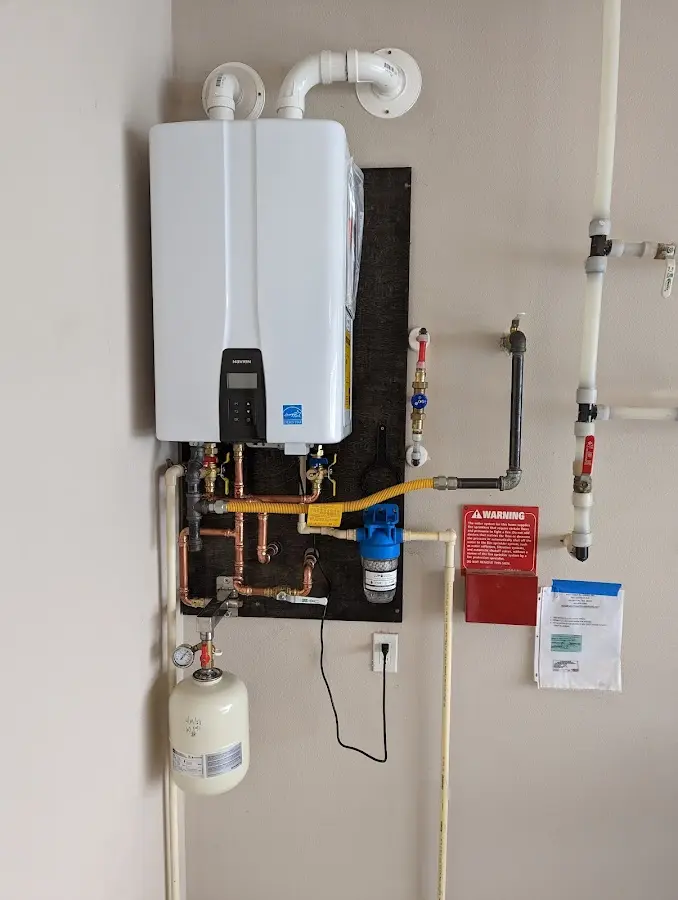 Professional plumber installing copper piping in a Gibsonville home